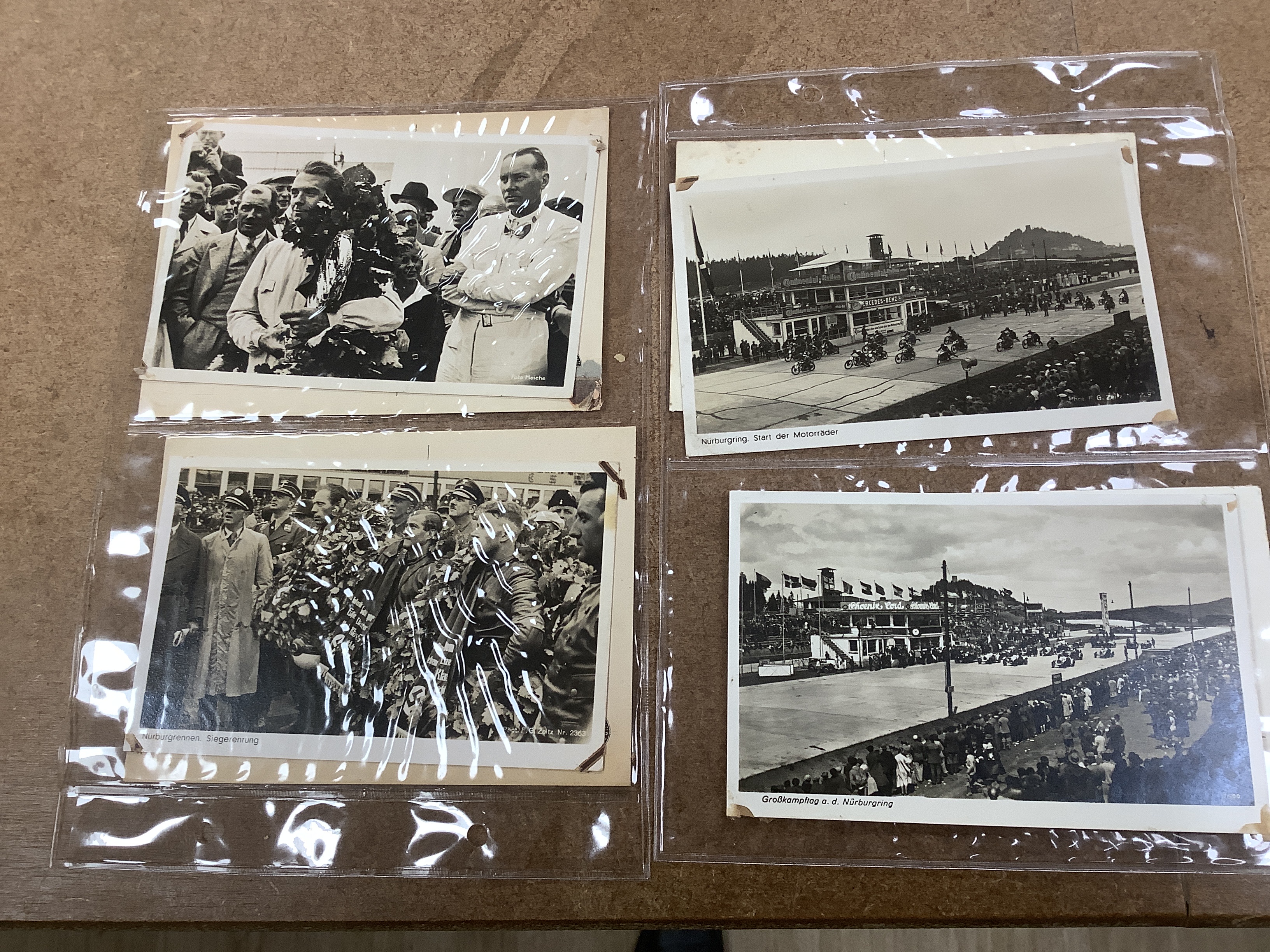 A postcard album, largely continental topography, and eight cards relating to car and motorcycle racing